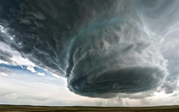 HD desktop wallpaper featuring a dramatic tornado forming under a massive, dark storm cloud over a vast plain.