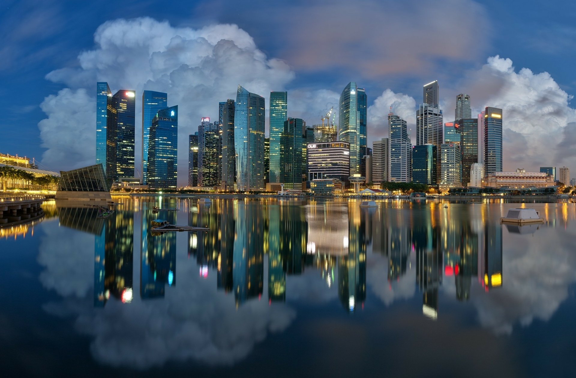 HD desktop wallpaper showcasing the man-made Marina Bay skyline in Singapore with vibrant city lights reflecting vividly on calm waters.