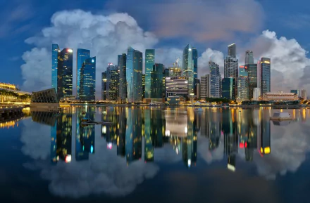 HD desktop wallpaper showcasing the man-made Marina Bay skyline in Singapore with vibrant city lights reflecting vividly on calm waters.