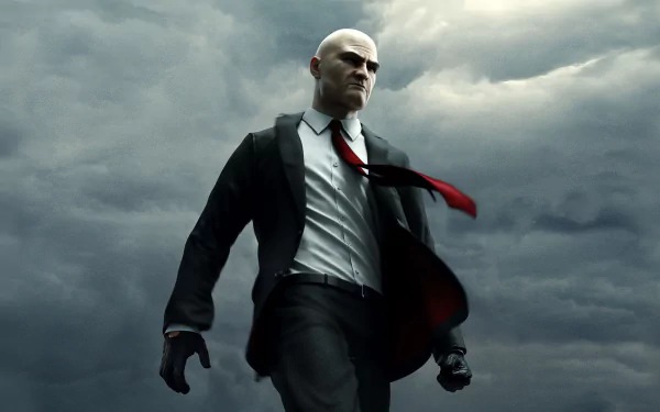 HD PC desktop wallpaper featuring Agent 47 from the Hitman video game series against a cloudy, ominous sky backdrop.