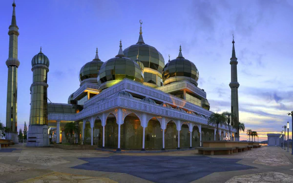 The image showcases The Crystal Mosque in Malaysia, noted for its stunning architecture and serene atmosphere, making it a captivating religious landmark.