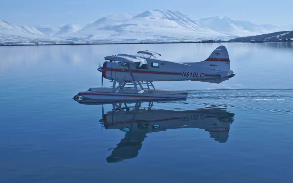 A De Havilland DHC-2 Beaver seaplane floats gracefully on calm waters, reflecting snow-capped mountains in wintery Sweden, creating a serene and picturesque scene.