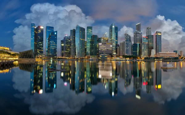 HD desktop wallpaper showcasing the man-made Marina Bay skyline in Singapore with vibrant city lights reflecting vividly on calm waters.
