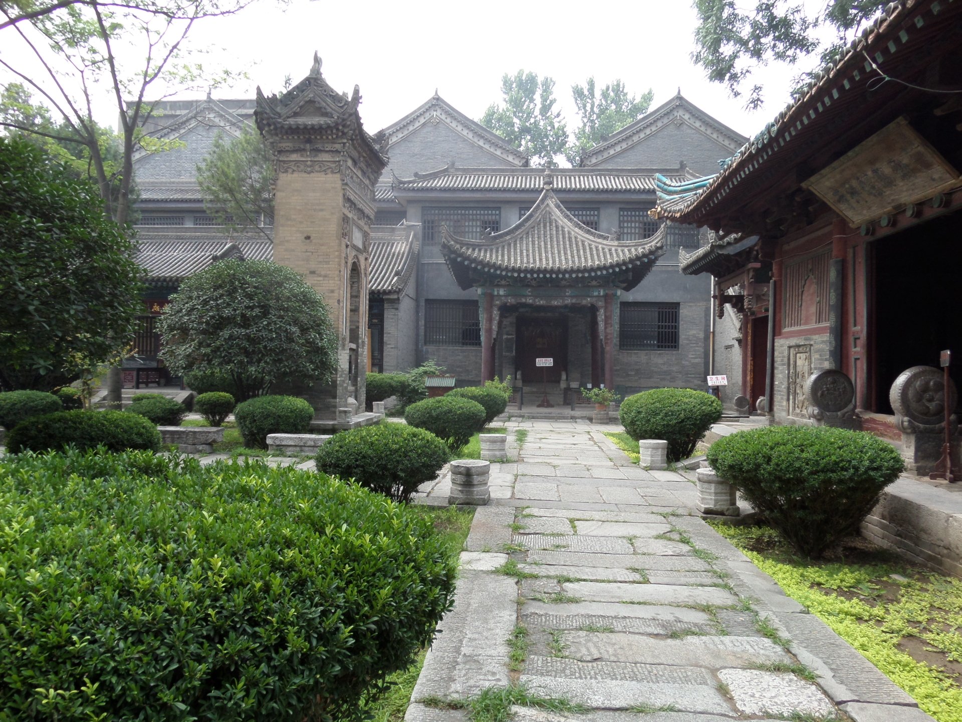 View of the historic Great Mosque of Xi'an in China, showcasing traditional architecture and lush greenery in a serene religious setting.