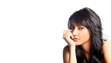 Close-up portrait of Bollywood celebrity Neha Sharma with dark hair against a white background, featured in HD PC desktop wallpaper and background style.