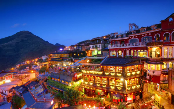 Vibrant night view of a man-made hillside village in Taipei, Taiwan, captured in stunning 4K Ultra HD detail.