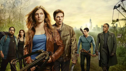A dramatic scene from the TV show Revolution, featuring a group of determined characters amidst a post-apocalyptic backdrop, making it a striking HD desktop wallpaper.