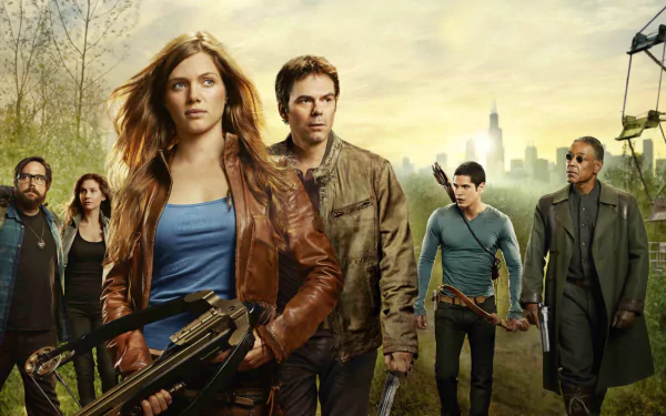 A dramatic scene from the TV show Revolution, featuring a group of determined characters amidst a post-apocalyptic backdrop, making it a striking HD desktop wallpaper.