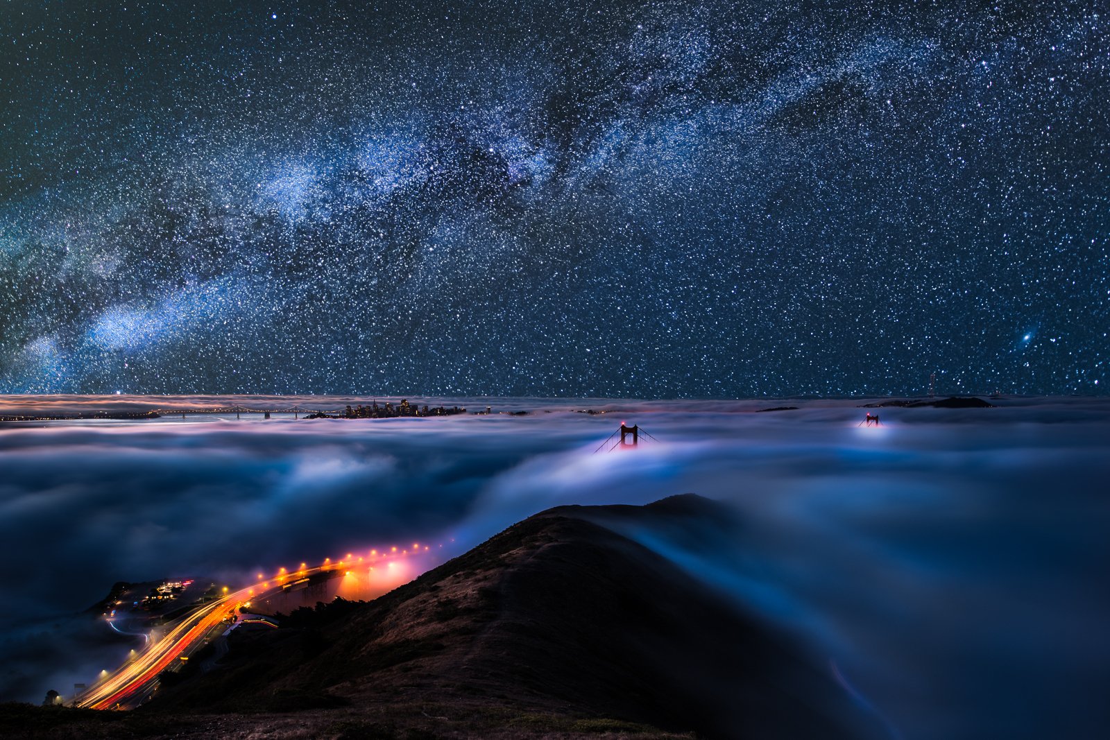 HD sci-fi desktop wallpaper showcasing a stunning time-lapse of stars and the Milky Way over a misty landscape with glowing city lights below.