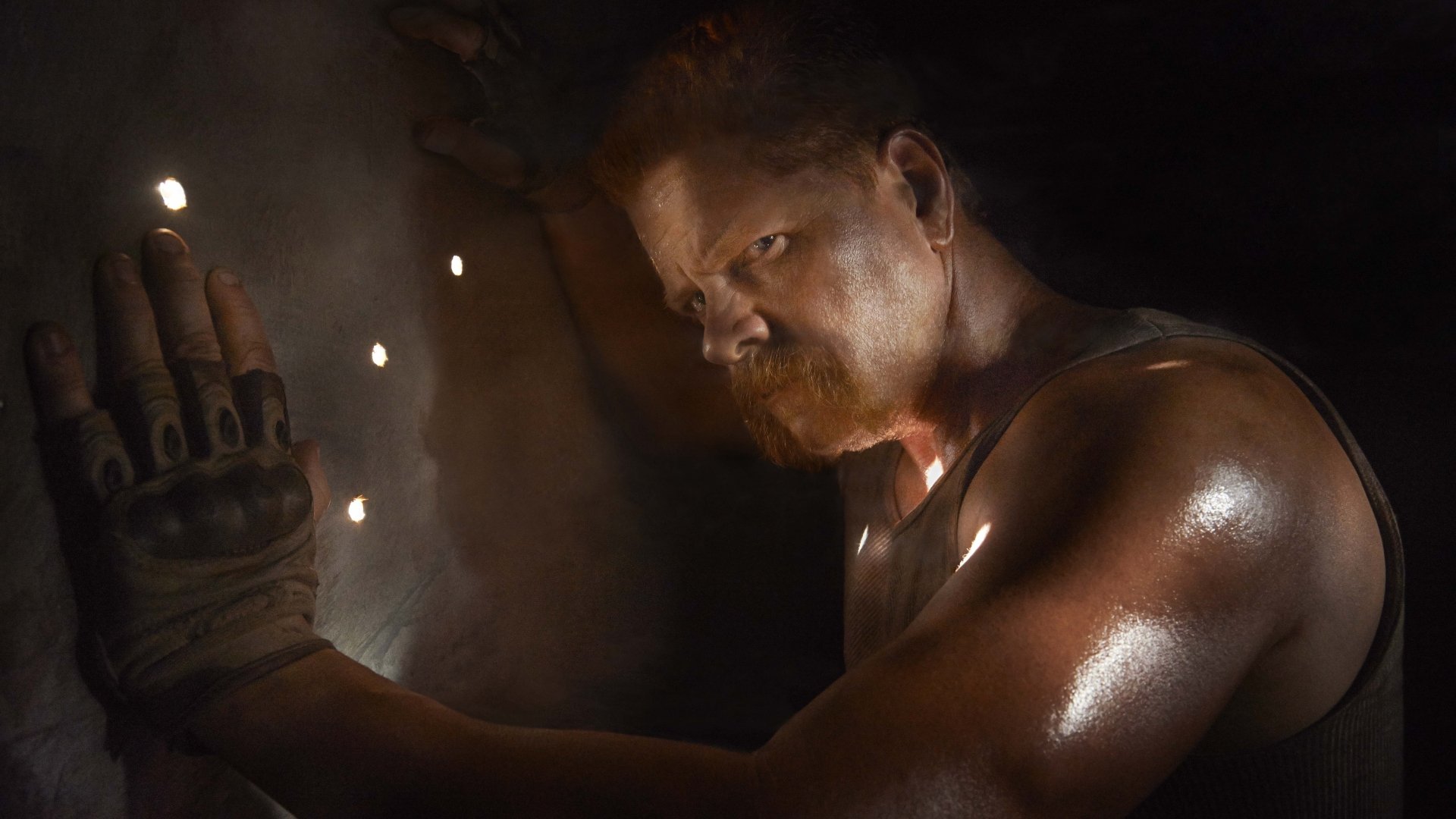 A character from The Walking Dead, illuminated in a dramatic scene, showcasing intense emotion and survival in a dark, atmospheric setting. 4K Ultra HD wallpaper.