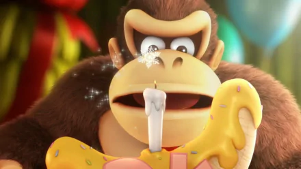 HD desktop wallpaper of Donkey Kong from Donkey Kong Country: Tropical Freeze, blowing out a candle on a banana-shaped cake.
