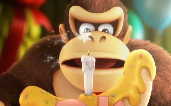 HD desktop wallpaper of Donkey Kong from Donkey Kong Country: Tropical Freeze, blowing out a candle on a banana-shaped cake.