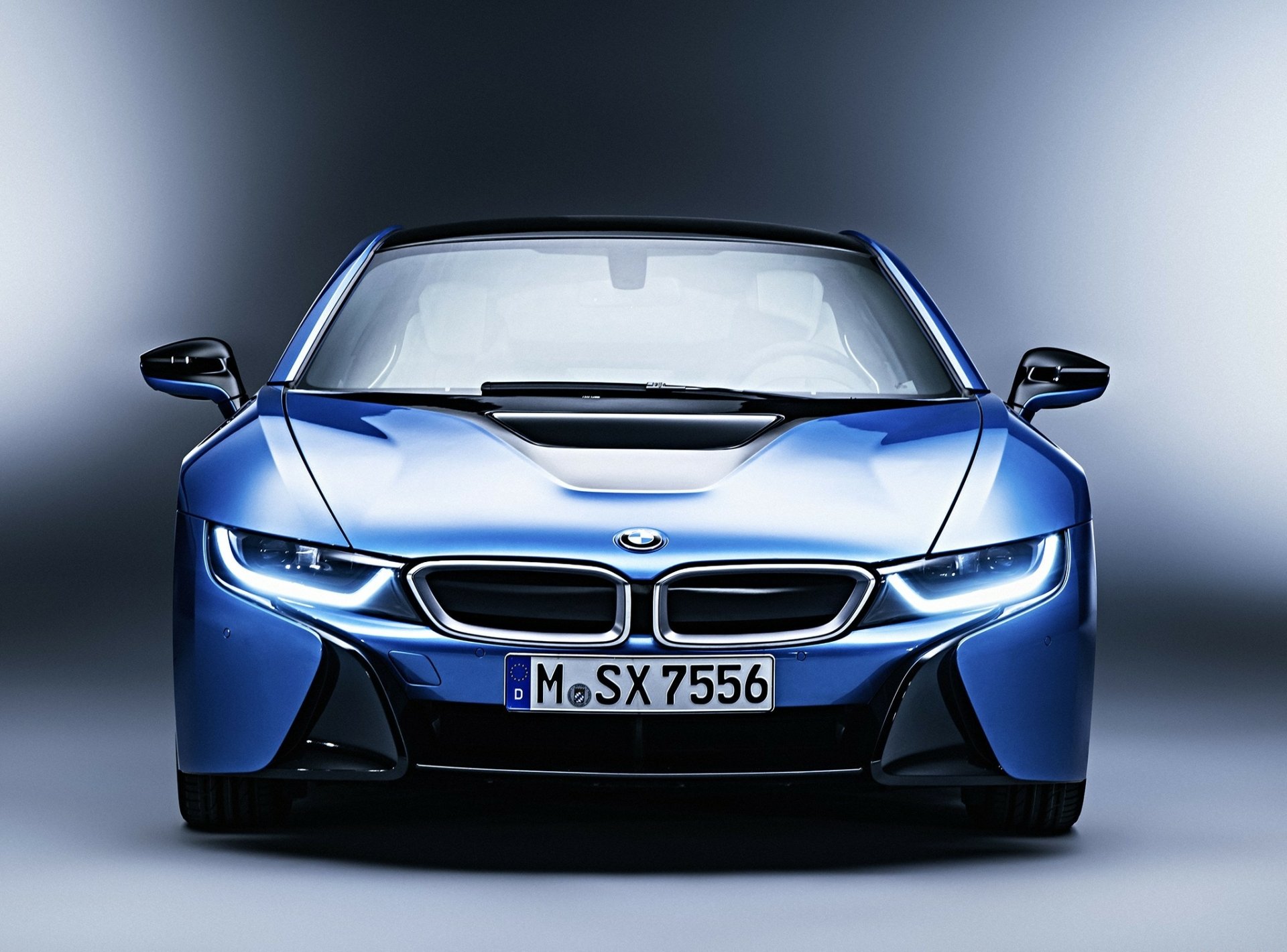 HD desktop wallpaper featuring a sleek blue BMW i8 vehicle showcased from the front against a gradient background.