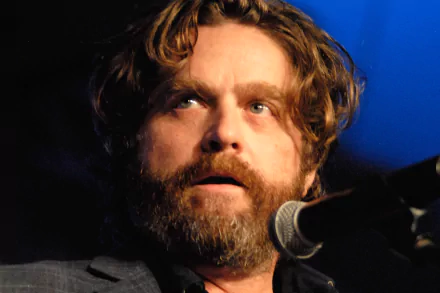 HD desktop wallpaper featuring a bearded man with a microphone in a blue-lit setting, providing a creative and engaging background.