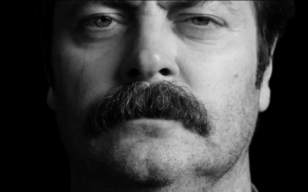 Black and white close-up of a man with a prominent mustache, serving as an HD desktop wallpaper background.