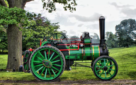 HD desktop wallpaper featuring a vintage green steam tractor in a lush, green countryside setting, highlighting its intricate design and vibrant coloration.