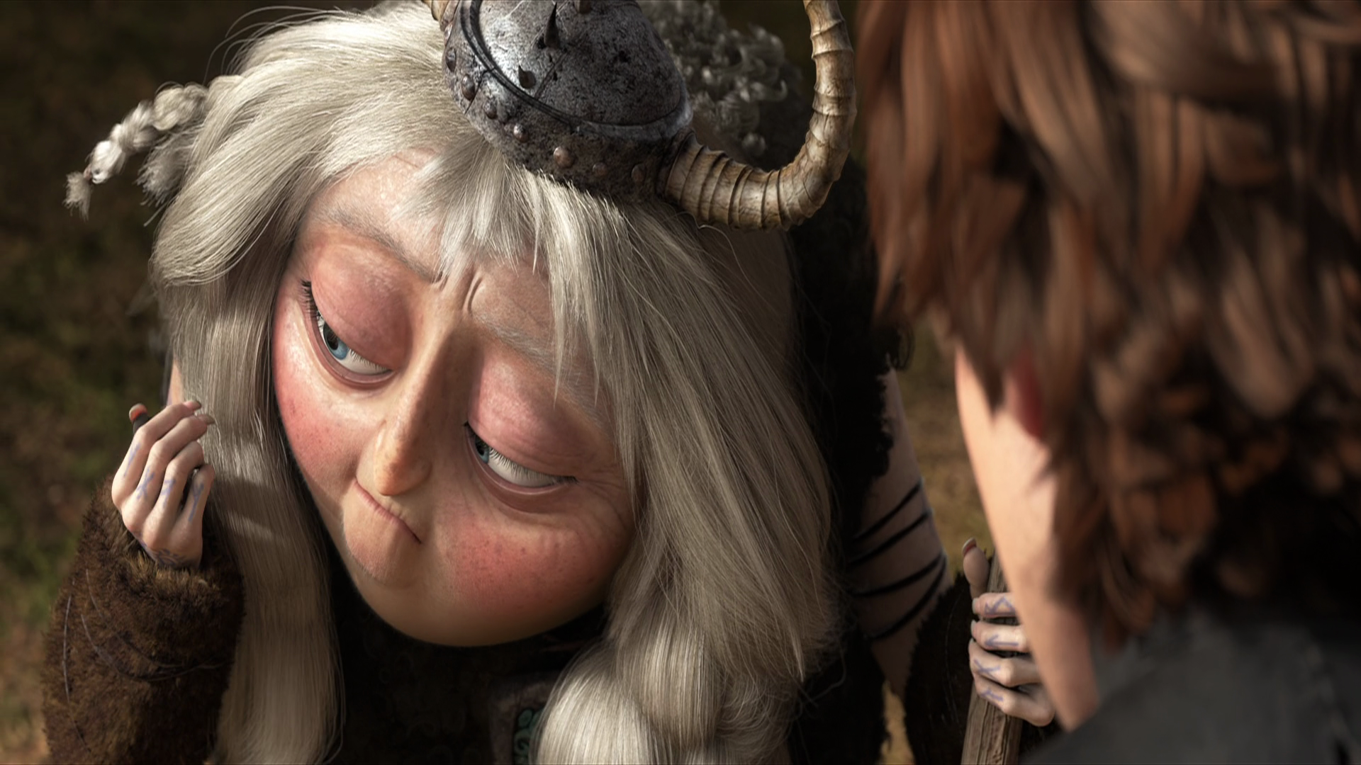 HD PC desktop wallpaper from the movie How to Train Your Dragon 2: close-up of Valka in a horned helmet gazing down, with Hiccup’s profile at the right.