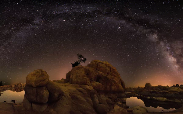 4K Ultra HD PC desktop wallpaper featuring a majestic Milky Way galaxy arching over rugged rocky terrain under a star-filled Sci-Fi night sky.