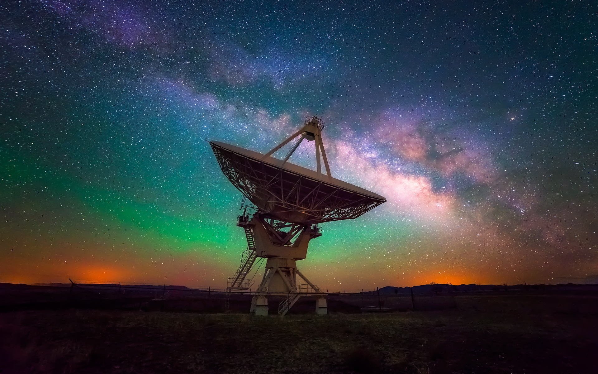 HD desktop wallpaper featuring a man-made telescope under a vibrant night sky filled with stars and the Milky Way galaxy.