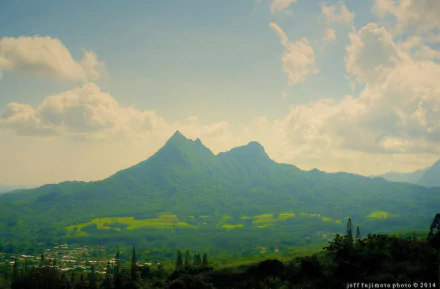 Bright sunshine illuminates a dazzling summer mountain ridge overlooking a lush green valley, captured in HD for a vivid PC desktop wallpaper and background.