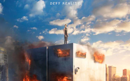 HD PC desktop wallpaper featuring a dramatic scene from the movie Insurgent with a character standing atop a burning structure under a cloudy sky and the text DEFY REALITY.