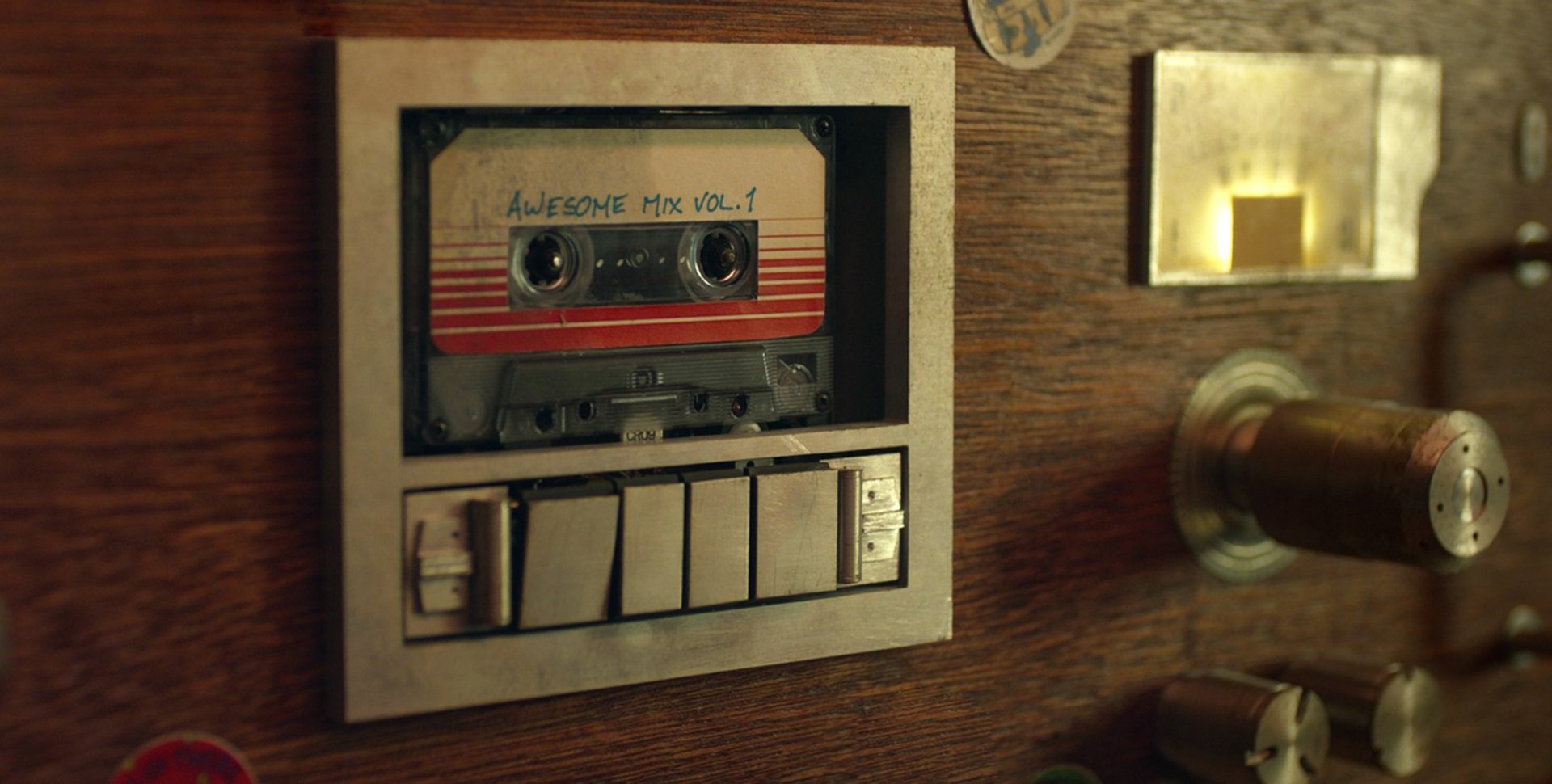 A close-up of a cassette tape titled Awesome Mix Vol. 1 set in a retro music console, inspired by the movie Guardians of the Galaxy, creating a nostalgic vibe for an HD desktop wallpaper.