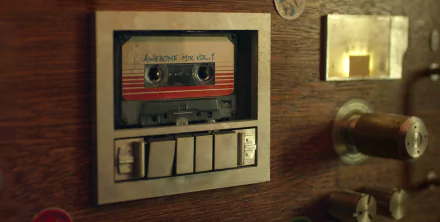 A close-up of a cassette tape titled Awesome Mix Vol. 1 set in a retro music console, inspired by the movie Guardians of the Galaxy, creating a nostalgic vibe for an HD desktop wallpaper.
