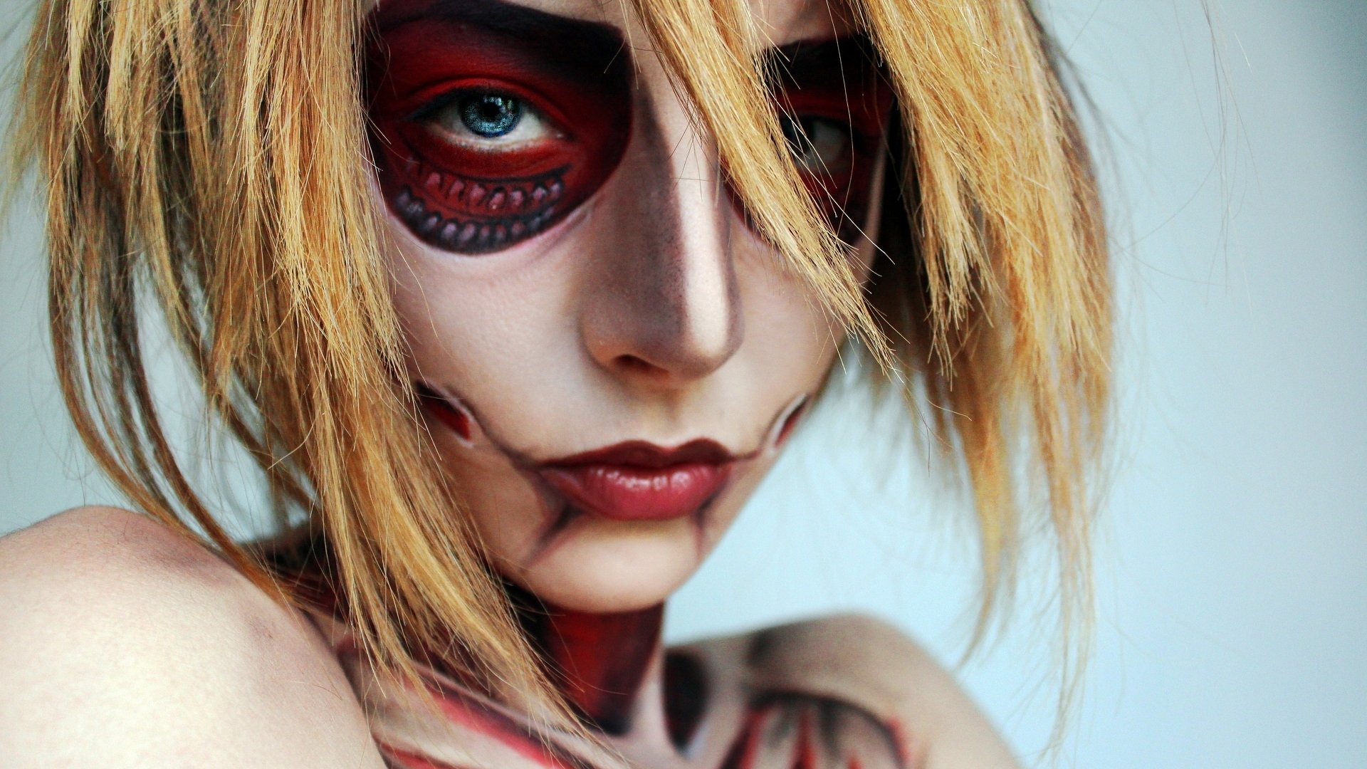 Artistic close-up of a person with detailed sugar skull makeup, featuring striking red and black designs, captured in HD for a PC desktop wallpaper background.