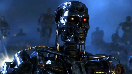 A high-definition desktop wallpaper featuring a close-up of a menacing robotic skull from Terminator Genisys, set against a dark, atmospheric background with other robots in the distance.
