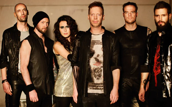Six-member rock band posed in leather and dark clothing against a beige backdrop — moody music-themed HD PC desktop wallpaper/background.