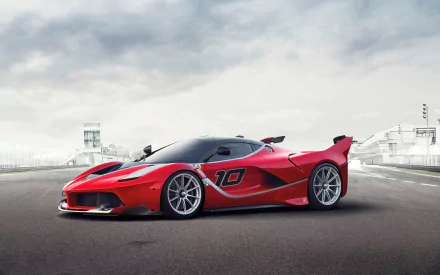 HD wallpaper featuring a 2015 Ferrari FXX K, a sleek red sports car with the number 10, parked on a racetrack under a cloudy sky.