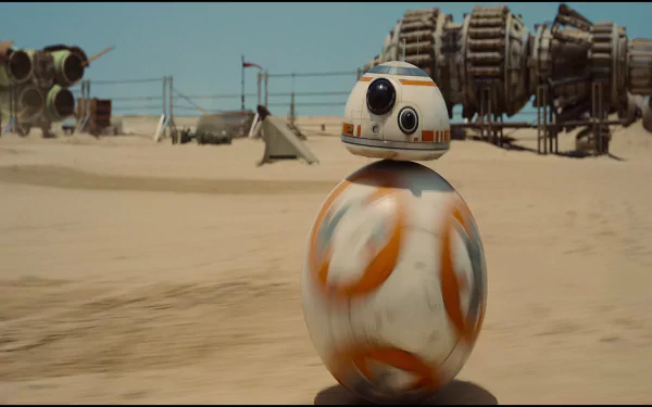 BB-8, the droid from Star Wars Episode VII: The Force Awakens, rolls through a sandy landscape, showcasing its iconic robotic design in this high-definition desktop wallpaper.