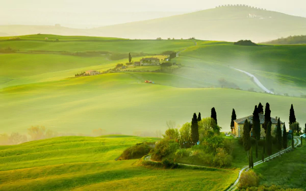 A serene Tuscany valley in Italy with rolling green hills and cypress trees, captured in 4K Ultra HD photography as a vibrant PC desktop wallpaper.