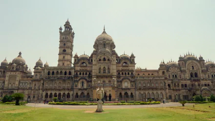 HD desktop wallpaper of the man-made Laxmi Vilas Palace in Vadodara, showcasing its grand architecture under a clear sky.