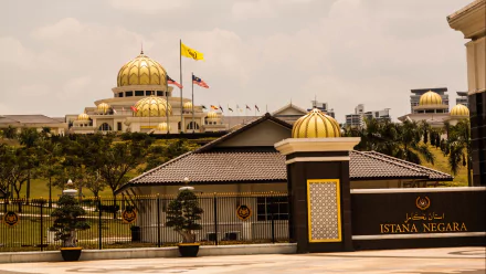 Man-made Istana Negara, Jakarta — golden domes and ornate gate set against a cloudy sky; HD PC desktop wallpaper/background.