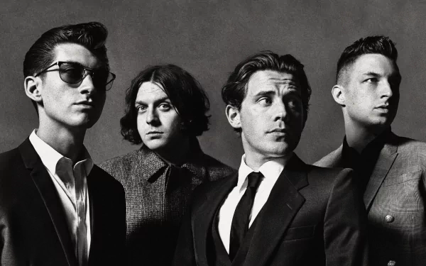 A striking black-and-white wallpaper featuring the English rock band Arctic Monkeys, showcasing the band members in a stylish and serious pose.
