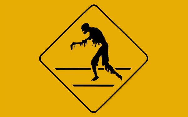 A dark-themed HD desktop wallpaper featuring a stylized zombie in a caution sign, perfect for fans of horror and the undead. The vivid yellow background enhances the eerie silhouette.