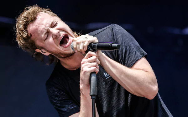 A dynamic performance by an American alternative band, Imagine Dragons, captures the intensity of their music in this vibrant 4K Ultra HD wallpaper.