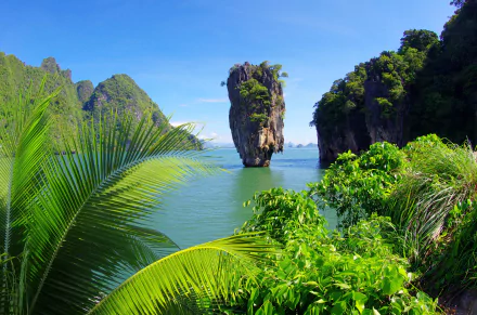A vibrant 4K Ultra HD view of Tropics' Tapu Island in Phang Nga Bay, Thailand, showcasing lush greenery, limestone cliffs, and serene lagoon waters near Phuket and Khao Phing Kan.
