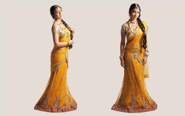 4K Ultra HD PC desktop wallpaper featuring celebrity Shriya Saran in an elegant yellow traditional outfit with detailed embroidery against a plain background.