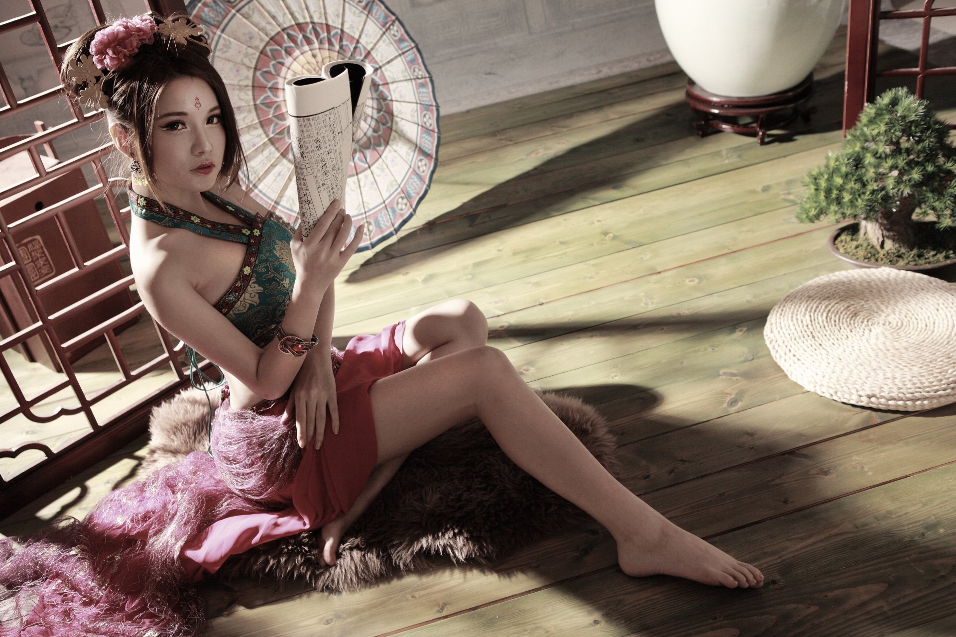 A Taiwanese woman with an umbrella sits elegantly on the floor, holding a book, surrounded by traditional decor. The image captures a blend of culture and beauty in stunning 4K resolution.