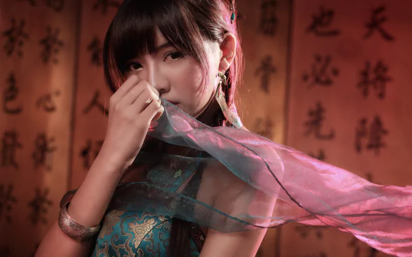 A Taiwanese woman in a veil poses gracefully against a backdrop of Chinese calligraphy, showcasing rich cultural heritage in this stunning 4K Ultra HD wallpaper.