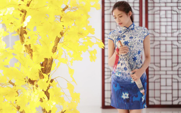 A woman in a blue floral dress holding an umbrella stands beside a vibrant yellow bonsai tree, captured in a 4K Ultra HD PC desktop wallpaper.