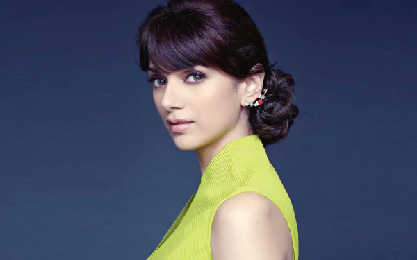 HD desktop wallpaper featuring celebrity Aditi Rao Hydari in a side profile, wearing a lime green top with a formal updo hairstyle against a dark background.