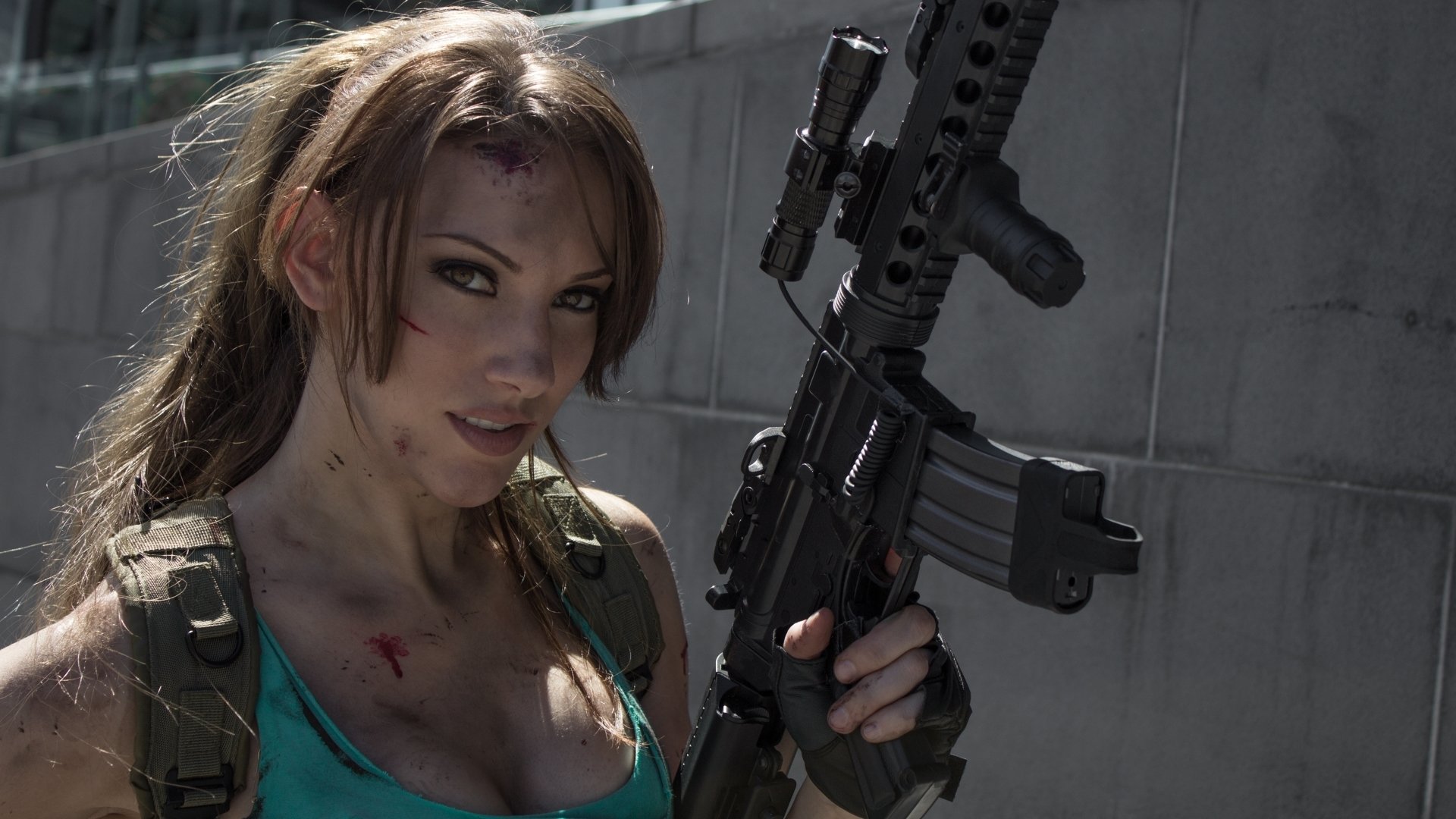 A woman in tactical cosplay holds a rifle, showcasing an intense expression and a detailed costume. This HD image serves as an engaging desktop wallpaper and background.