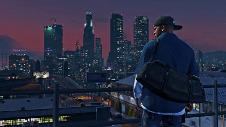 A HD desktop wallpaper featuring Franklin Clinton from Grand Theft Auto V, overlooking a cityscape at dusk.
