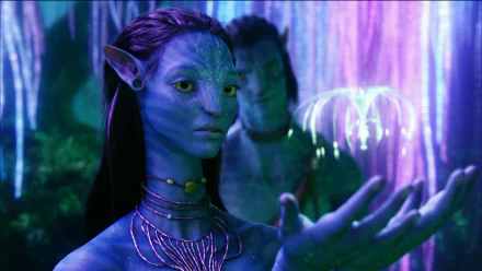 HD PC desktop wallpaper featuring characters from the movie Avatar, showcasing a detailed close-up of a blue-skinned Na'vi in a glowing, bioluminescent forest setting.