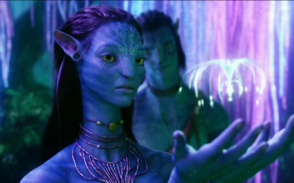 HD PC desktop wallpaper featuring characters from the movie Avatar, showcasing a detailed close-up of a blue-skinned Na'vi in a glowing, bioluminescent forest setting.
