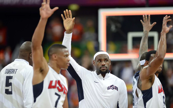 4K Ultra HD basketball wallpaper showing USA team players raising their hands on a court during a game.