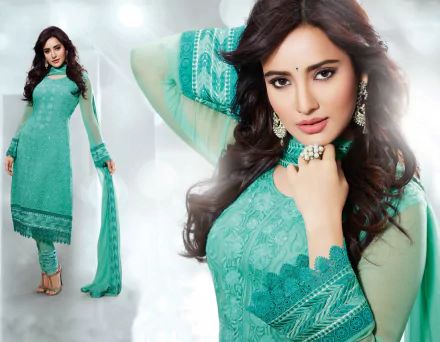 Neha Sharma poses elegantly in traditional Indian national dress, featuring intricate turquoise detailing, set against a soft, glowing background. An eye-catching HD wallpaper choice.